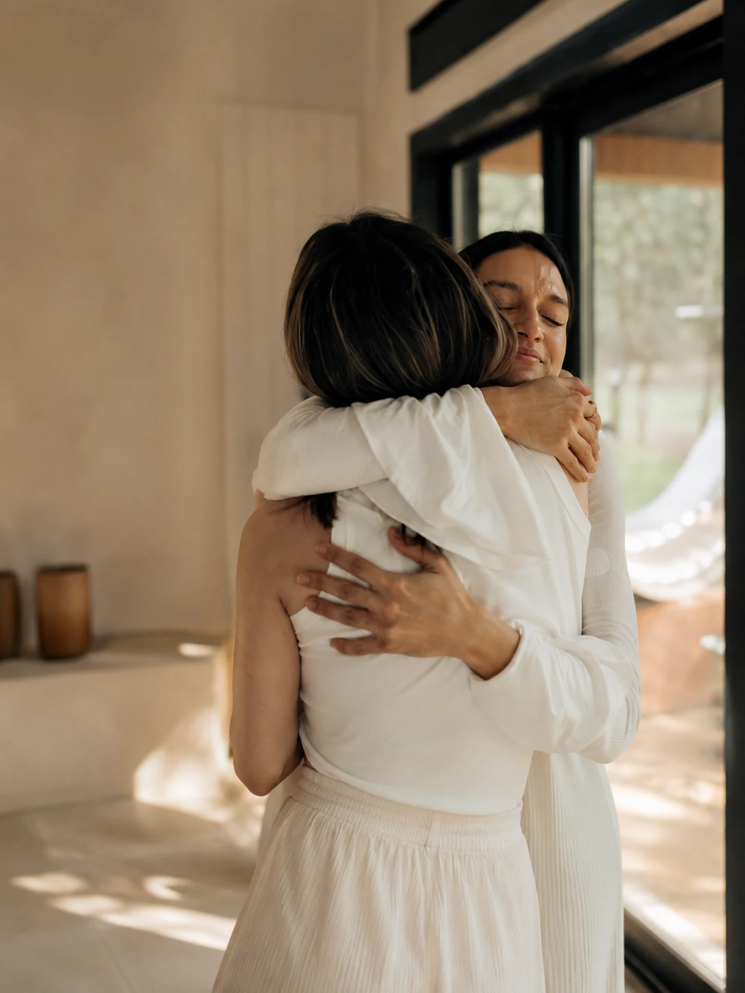 Two members embracing warmly in the studio